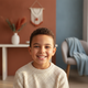 Close-up portrait of a happy child smiling, conveying trust and satisfaction.